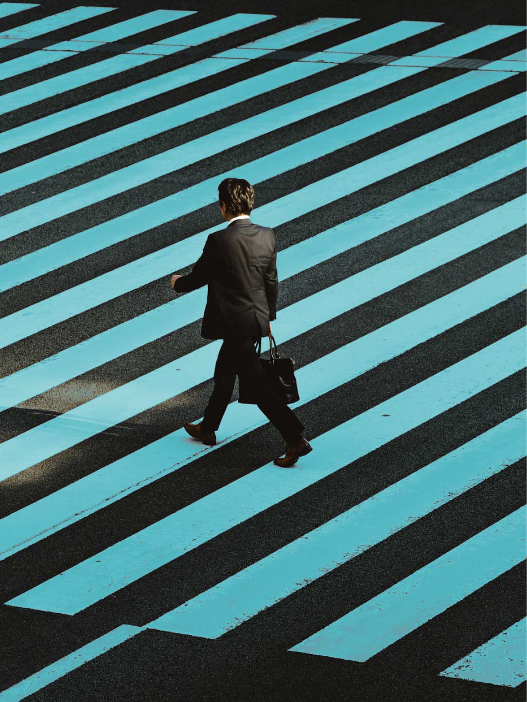 man walking on crossing stripes