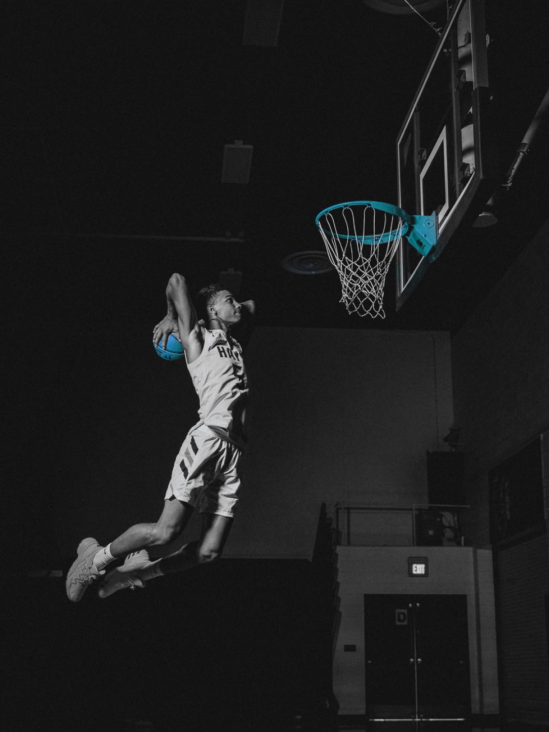 man jumping towards a basketball net